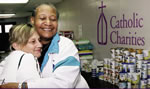 Catholic Charities voluteers hand out hugs and canned goods 